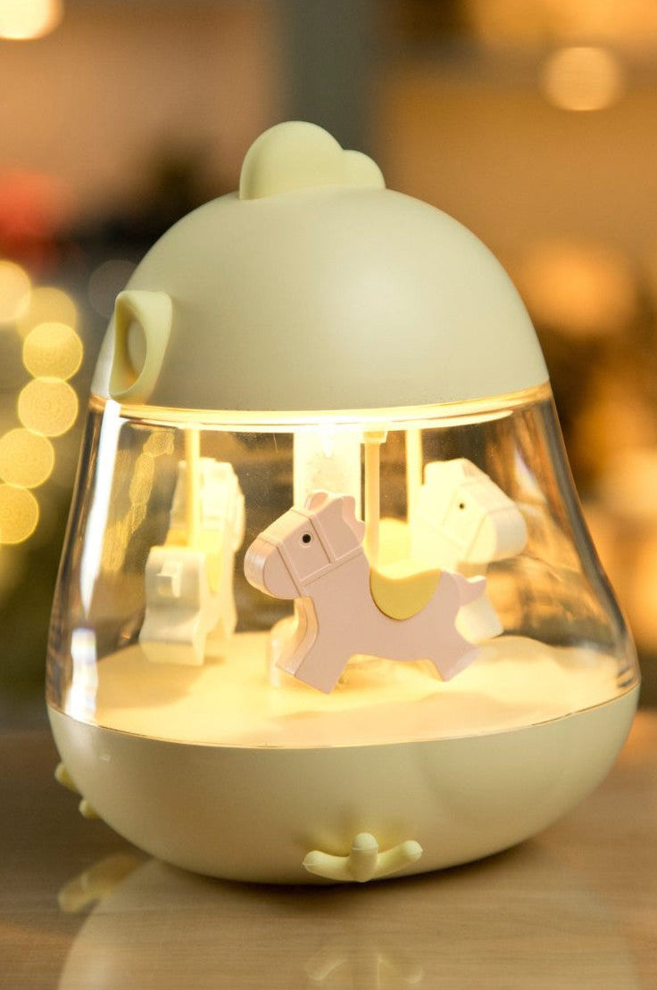Decorative night light with small animals inside on a blurred background